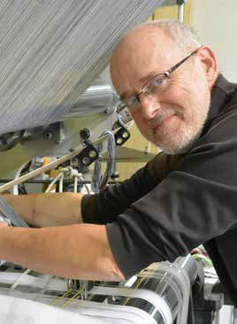 Man in front of a textile machine